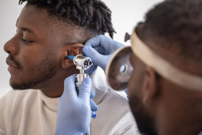 ENT Perforated Eardrums Man having his ear inspected for a perforation by his doctor