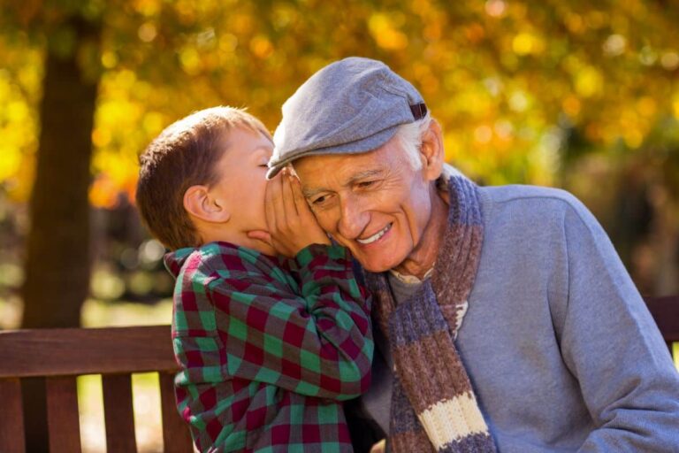 Otosclerosis-symptoms Child speaking into grandfathers ear as the grandfather smiles